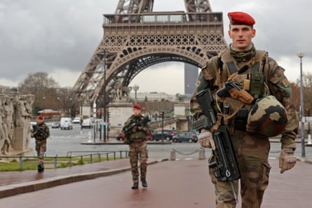 French army paratroopers patrol near the Eiffel Tower in Paris