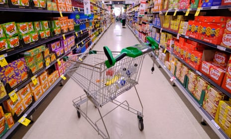 A trolley in the middle of a supermarket aisle