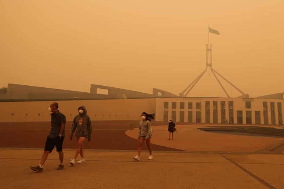 Visitors to Parliament House in Canberra wear face masks as bushfire smoke blankets the Australian capital in January 2020.