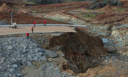 Crew members inspect the erosion just below the Lake Oroville emergency spillway.