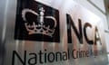 Sign on a wall saying: 'NCA National Crime Agency' with a picture of a crown