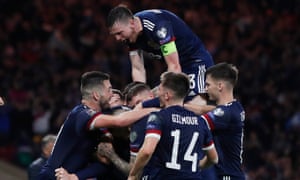 Scotland’s Scott McTominay celebrates scoring their third goal with teammates.
