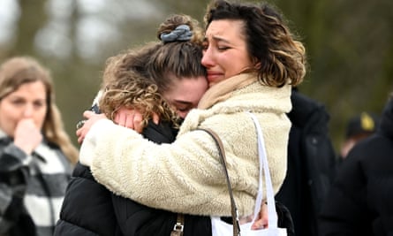 Two women embrace as they stand before tributes for Sarah Everard at the bandstand on Clapham Common on 13 March.