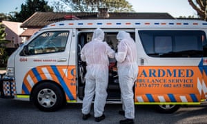 A crew of a private ambulance service in Port Elizabeth wear personal protective equipment before checking a patient.