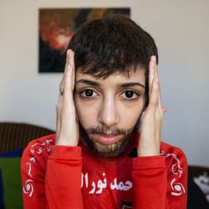 Zeinab applies a wig and facial hair as part of her disguise.