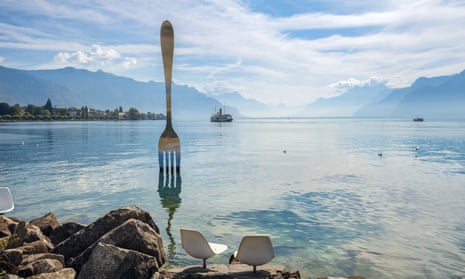 Landscape with fork sculpture in Geneva lake by artist Jean-Pierre Zaugg. Vevey, Switzerland