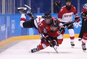 Shoko Ono of Japan falls on top of Dominique Ruegg of Switzerland in the second period of their women’s ice hockey preliminary round game.