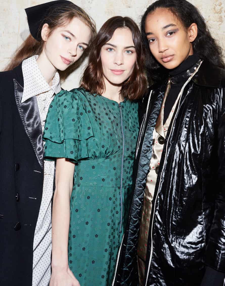 Alexa Chung with two models backstage.