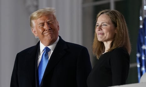 Donald Trump and Amy Coney Barrett stand on the Blue Room balcony after her swearing-in as a supreme court justice in October 2020.