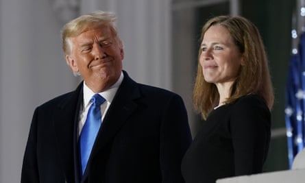 Donald Trump beams alongside Amy Coney Barrett at the White House following her confirmation as a supreme court justice.