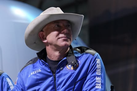 Jeff Bezos wears a Blue Origins jacket and a cowboy hat during a post launch briefing on 20 July.