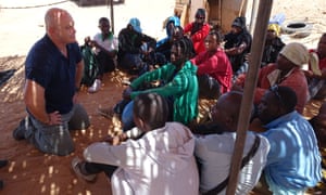 Ross Kemp with migrants waiting to be picked up