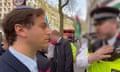 Gideon Falter speaking to a Metropolitan police officer during a pro-Palestine march in London