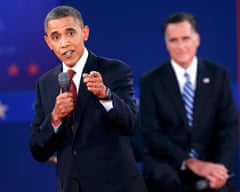 Barack Obama answers a question as Republican presidential nominee Mitt Romney looks on during the second presidential debate in 2012