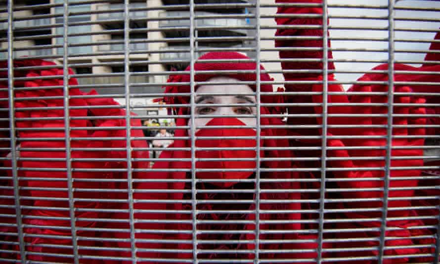 Members of Extinction Rebellion Red Brigade protest outside the Cop 26 venue in Glasgow.