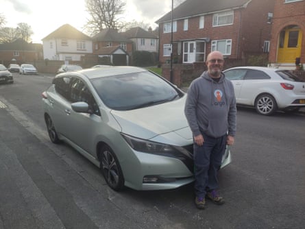 Alan Clucas with his Nissan Leaf parked in the street
