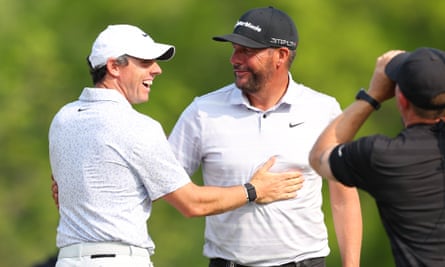 Michael Block celebrates his hole in one with Rory McIlroy.