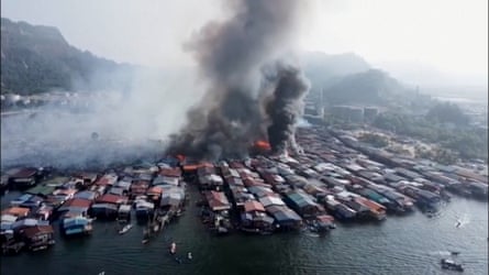 smoke billows from a occurrence destroying stilt houses successful a coastal village