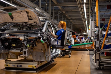 A Volkswagen employee works on the assembly of an electric ID.3 model at the factory in Zwickau.