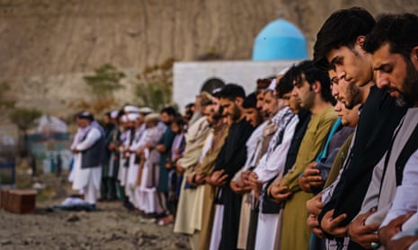 People attend a mass funeral for the 10 killed in a US drone strike in Kabul. 
