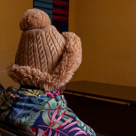 A woman in a woolly hat looks away from the camera