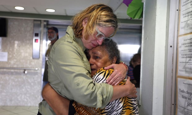 Carmen Yulín Cruz hugs a woman during her visit to an elderly home in San Juan on 22 September 2017.