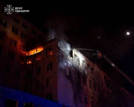 A rescuer works at a site of a damaged business centre hit during Russian military strike in Odesa, Ukraine.