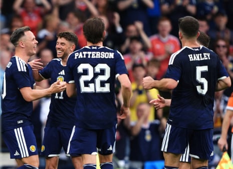 Lawrence Shankland (left) celebrates scoring Scotland’s second goal of the game with this teammates.