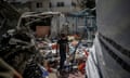 Boy walks through rubble of bomb damaged buildings