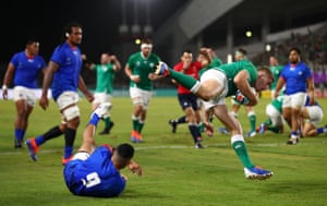 Jordan Larmour of Ireland scores his team’s fifth try past Dwayne Polataivao of Samoa.