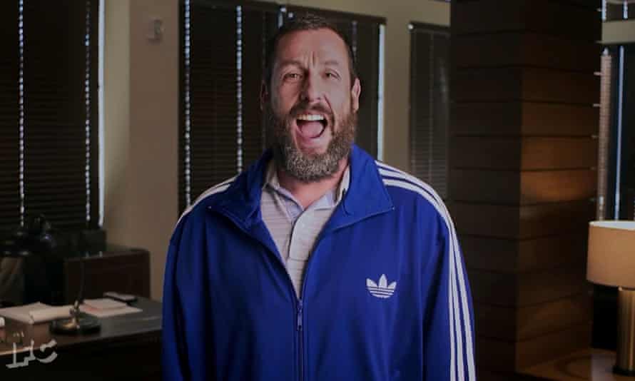 Sandler opts for an Adidas tracksuit top instead of a conventional suit as he presents an award at a ceremony in Los Angeles.