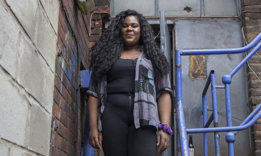 DJ Ifeoluwa standing outside what looks like the back door of a club