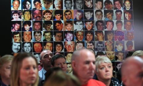 Photographs of the 96 victims behind family members at the press conference.