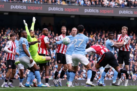 Kevin Schade of Brentford shoots which is saved by Gianluigi Donnarumma of Manchester City