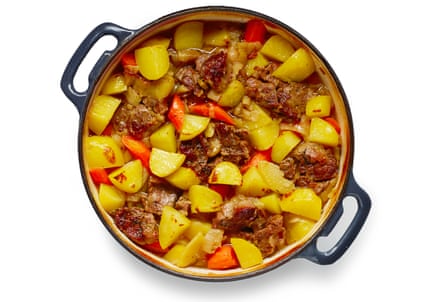 Potatoes, onions, meat and carrots in a pan