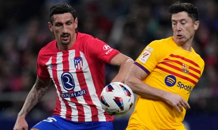 Barcelona’s Robert Lewandowski (right) vies for the ball with Atlético Madrid’s Stefan Savic