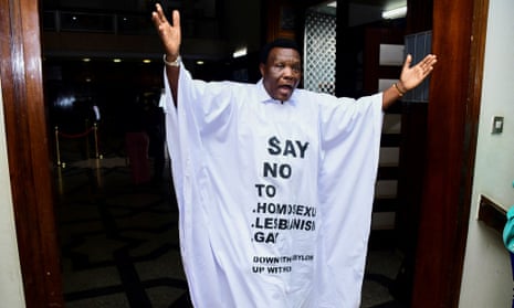 Ugandan MP John Musila dressed in an anti-gay T-shirt as he leaves the chambers during the debate of the anti-homosexuality bill.