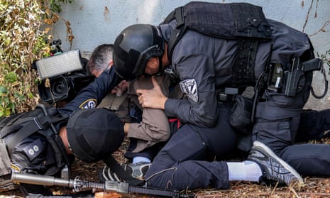 Israeli police and security forces assist a journalist taking cover during an alert for a rocket attack in Israel’s southern city of Sderot near the frontier with Gaza.