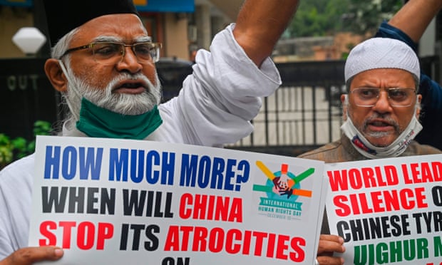Protesters in Mumbai hold placards during a protest against the Chinese government’s policies on Uighur people.