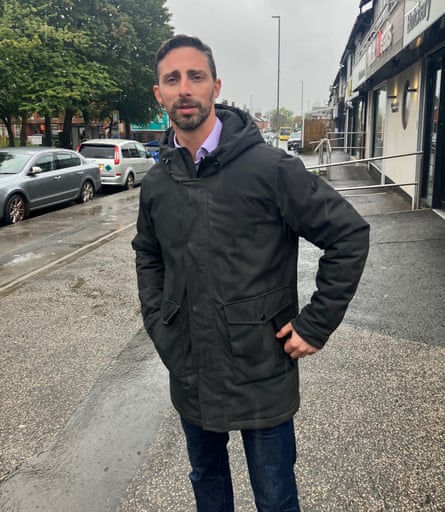 Man stands in street.
