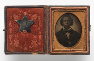 Creed Miller and his silver civil war identification badge from 1864. He fought as a soldier in the United States Colored Troops against slavery in the civil war