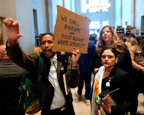 Justin Jones, left, protests outside the House chamber with fellow Democrats Gabby Salinas, front right, and Gloria Johnson, behind, during a special session of the state legislature to redraw US congressional voting maps on 7 May.