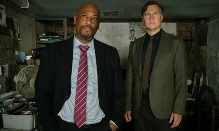 Sergeant Cleaver (Terence Maynard) and DCS Ian St Clair (David Morrissey) in Scott's cell.