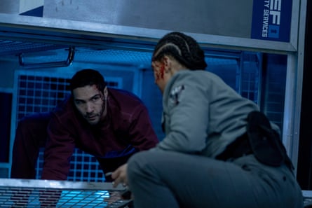 Tahar Rahim and Izuka Hoyle in a scene from Prisoner. He is climbing out of a crate. She is looking at him. They both have blood on their faces