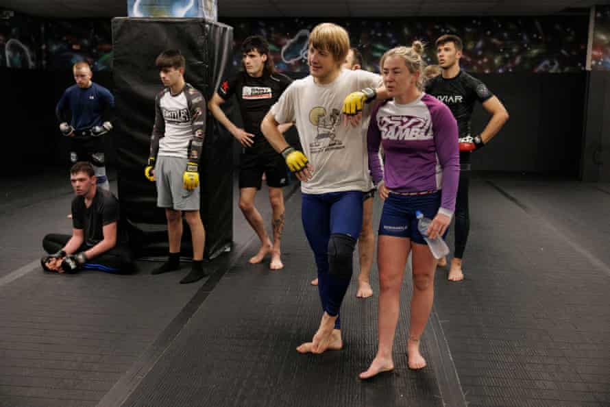 Paddy Pimblett leans on Molly McCann during a training session.
