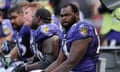 Michael Oher sits on a bench during an NFL game