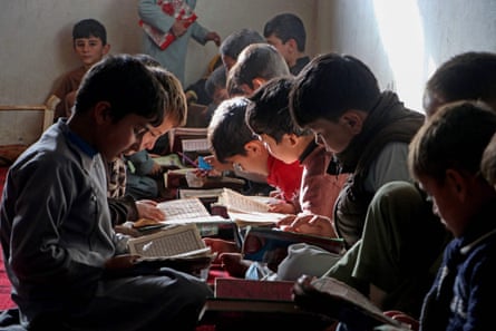 Afghan children read the holy Koran at a madrassa or an Islamic school in the Fayzabad district of Badakhshan province on November 20, 2023.