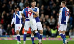 Blackburn Rovers' Scott Wharton (centre) and Ryan Hedges celebrate at full time after the win that put them top of the Championship