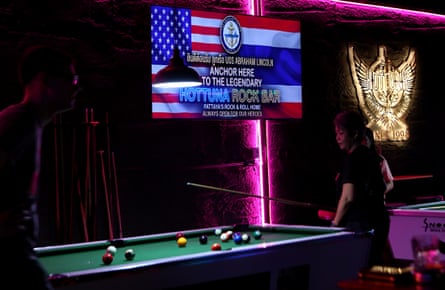 A large screen welcoming the U.S. navy personnel is displayed inside a bar