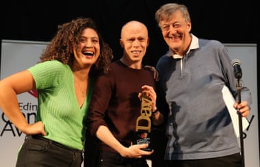 Brookes receives his trophy at the Dave’s Edinburgh Comedy awards from 1981 winner Stephen Fry and 2018 best comedy show winner Rose Matafeo.